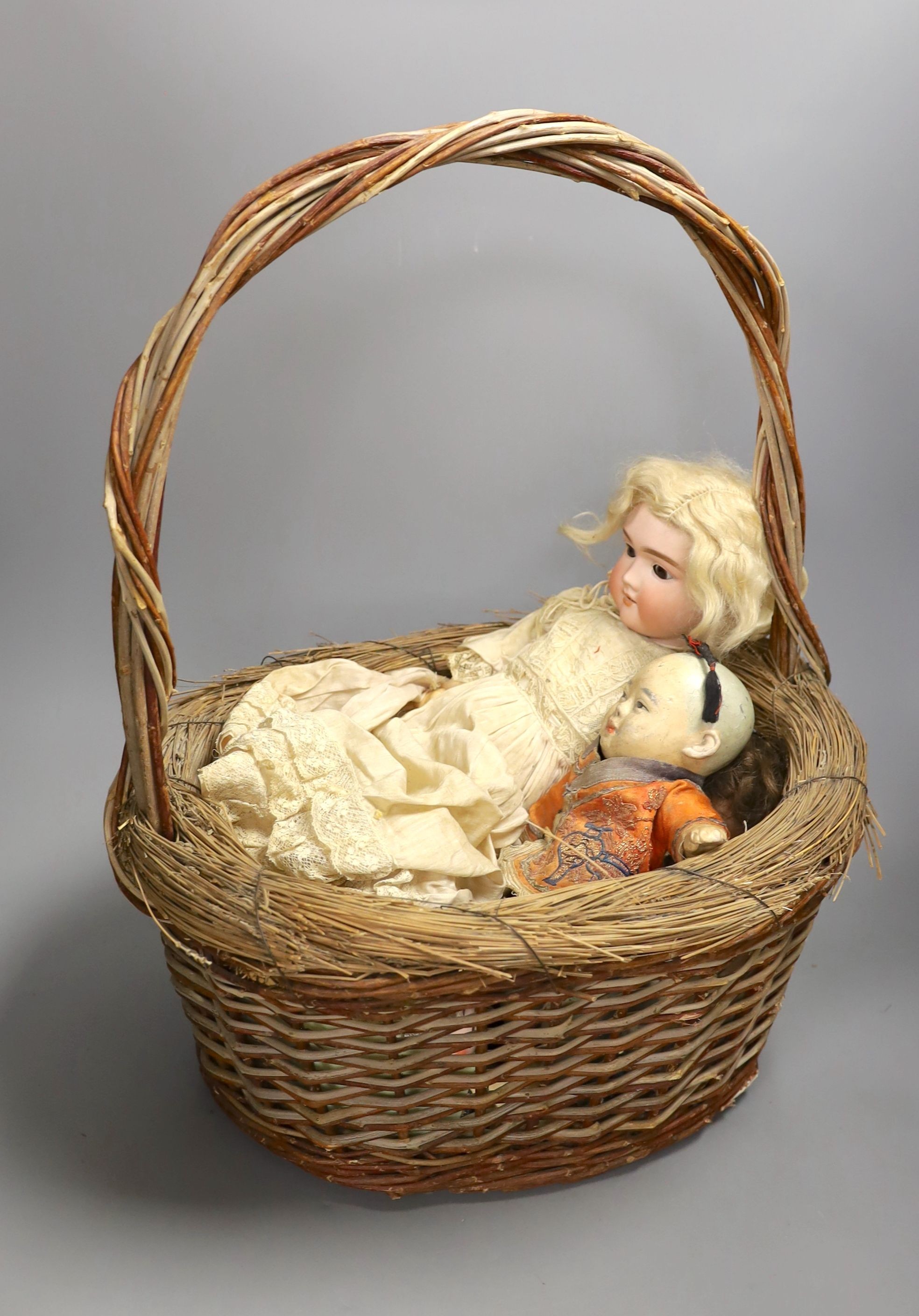 An early 20th century Max Handwerke bisque doll with open mouth and sleeping eyes, H 46 cms, one other smaller German bisque doll, a composition Chinese baby doll and nine others, some miniature and incomplete.